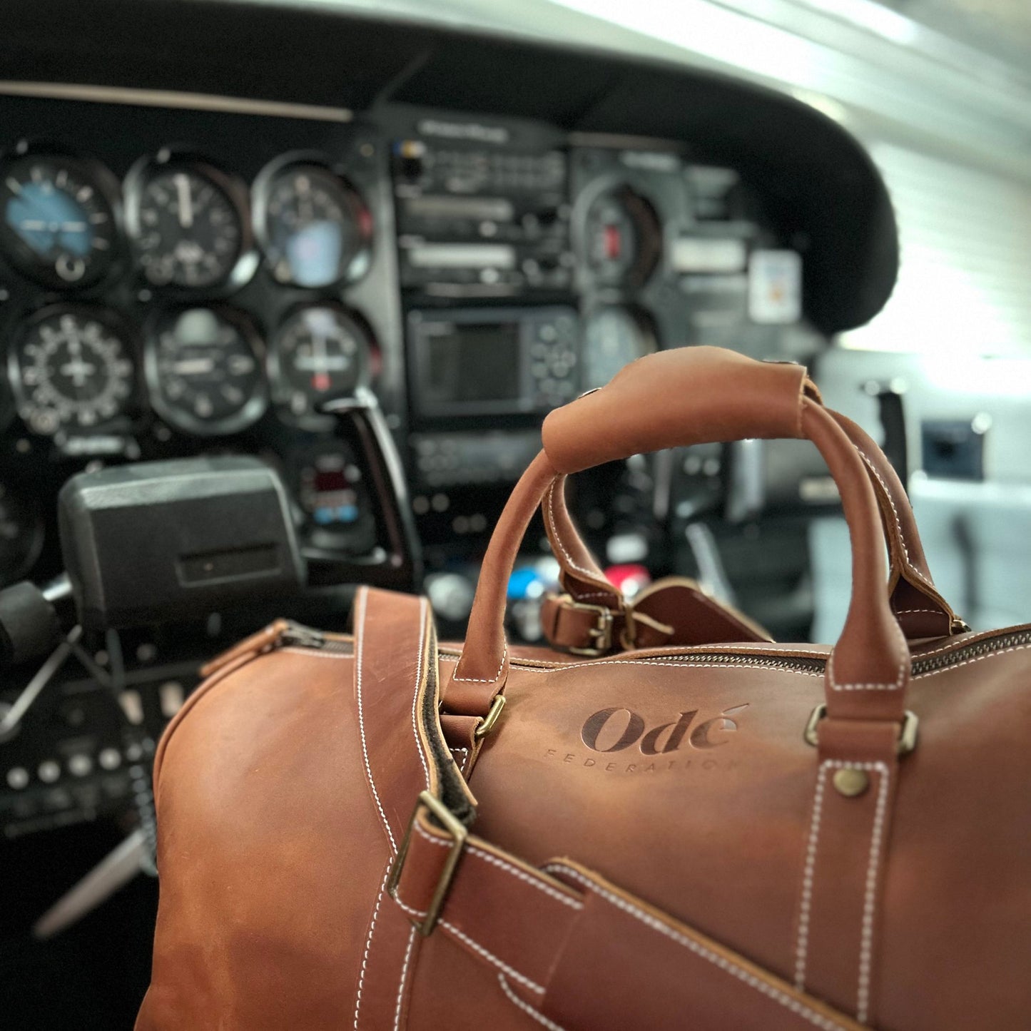 leather duffle bag in a plane